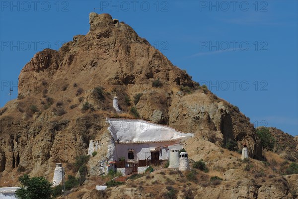 Mountain with cave house in cave district of Guadix