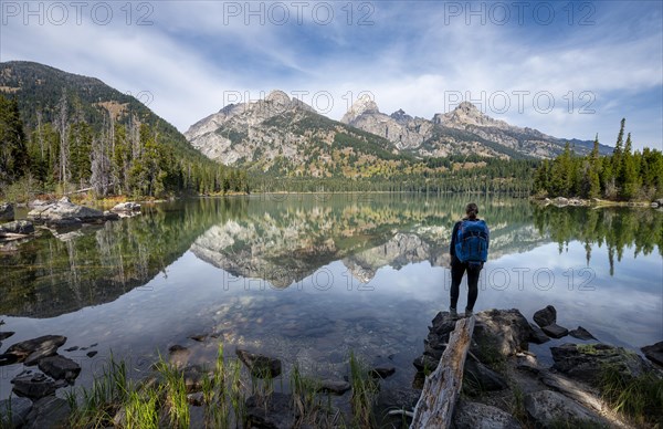 Young woman standing at a lake