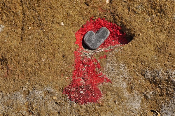 Stone as heart symbol in rocks with red colour
