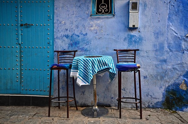 Alley with bar table and two high chairs