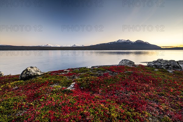 Autumnal fell landscape with lake Akkajaure and mountain range Akka