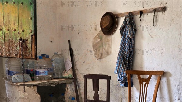 Abandoned finca as a workroom with chairs and wardrobe