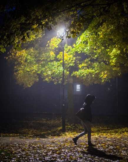 A woman walks through a lonely park in Markt Swabia