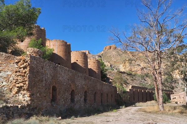 smokestacks on mine site with mountain