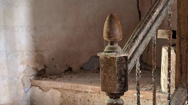 Staircase with banister knob in abandoned house