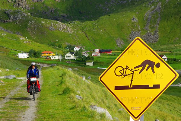 Falling cyclist on traffic sign