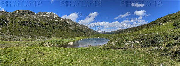 Small mountain lake near Tschuggen with view of Davos