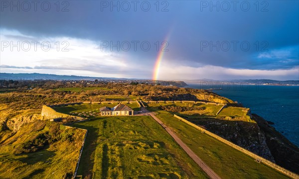 Rainbow over Brixham from Berry Head in the rays of the rising sun