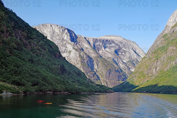 Kayakers in front of high cliffs