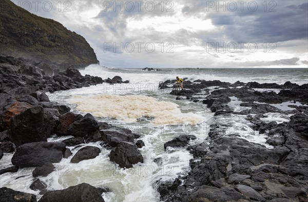 Natural thermal bath Termas da Ferraria at high tide with high waves