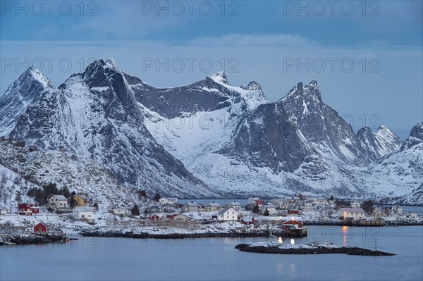 Winter Scandinavian landscape with illuminated houses
