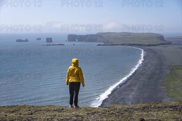 Young woman looking over Reynisfjara Beach