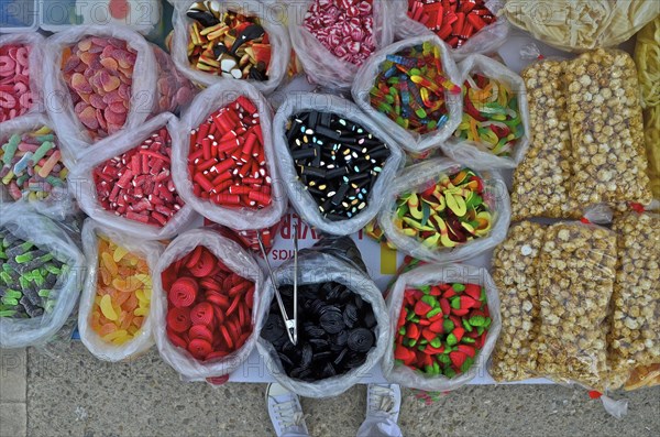 Plastic bags with sweets on market