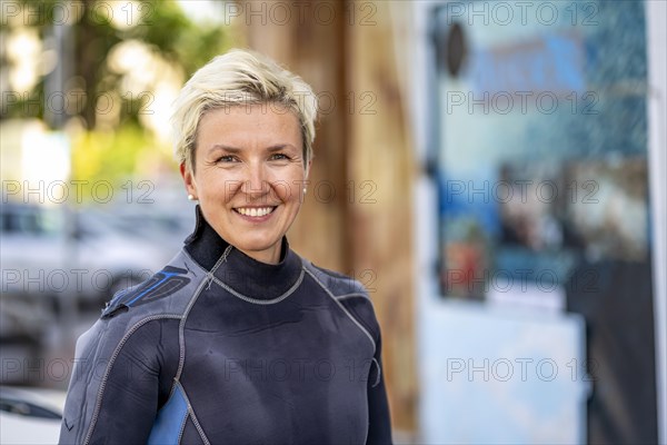 Portrait of a happy scuba diver with wet suit already on