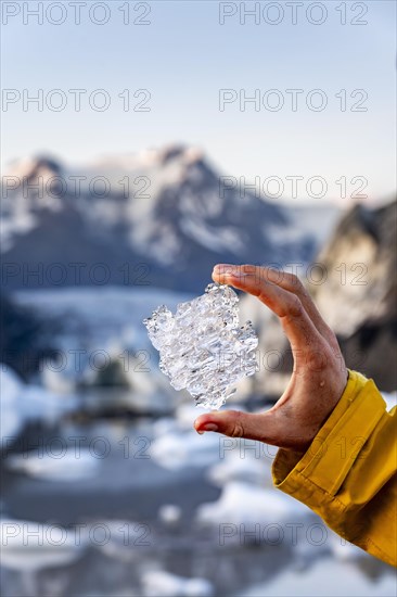 Hand holding glacial ice