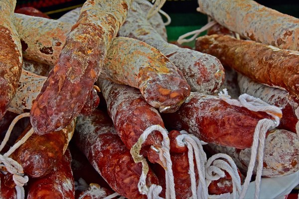 Several hard sausages in display