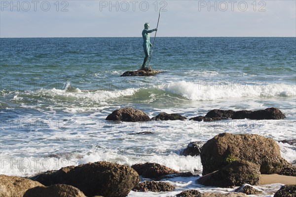 Sculpture of Neptune in sea near the beach