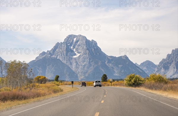 Country road in front of Grand Teton Range mountain