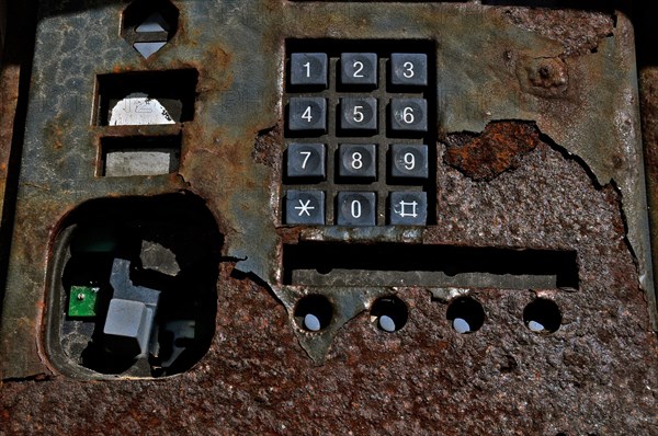 Rusty and broken public telephone