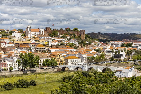 Silves cityscape with Moorish castle and cathedral on the top of the hill