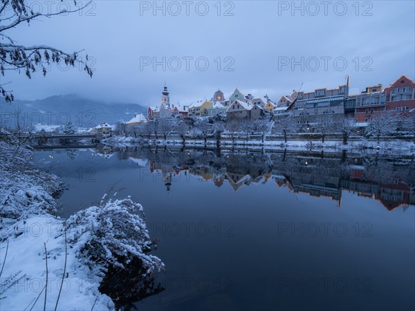 House facade of Frohnleiten reflected in the river Mur