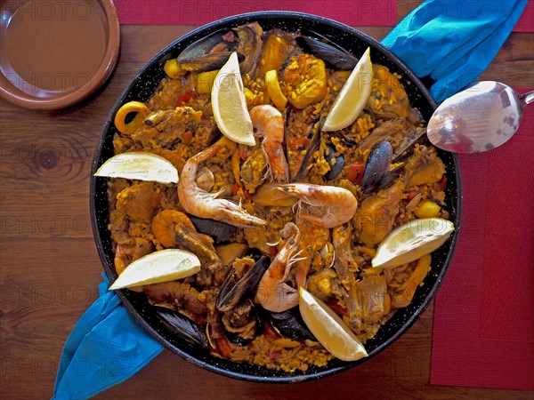 Typical paella pan on wooden table