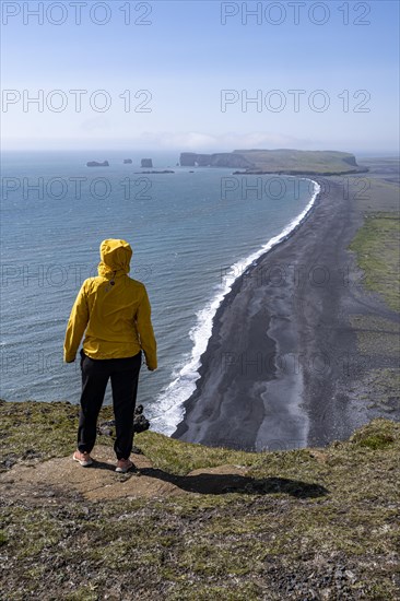 Hiker looking over Reynisfjara Beach