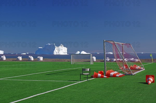 Football ball with goals in front of icebergs