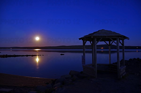 Full moon over a body of water