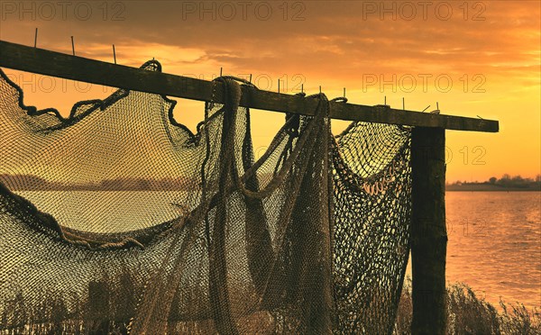 Suspended fishing nets in the sunset