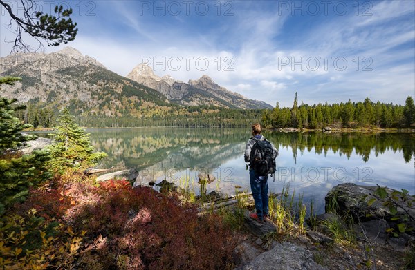 Young man standing by a lake