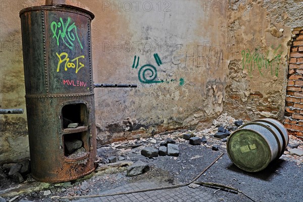 Coal stove and oil barrel in warehouse at Canfranc railway station