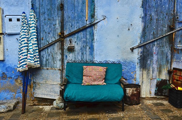 Green sofa in front of blue doors