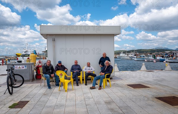 Sardinian seniors meet in the harbour area of Figari at Golfo Aranci