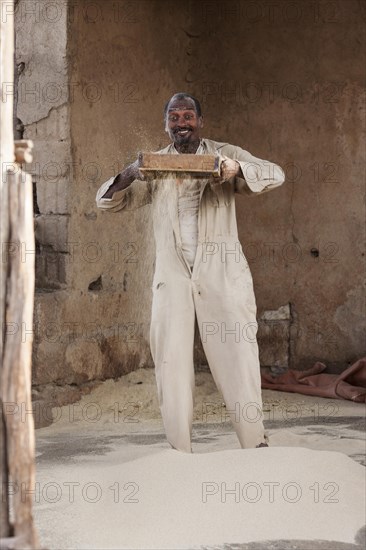 Man sifts flour