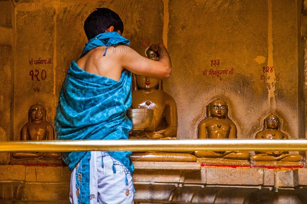 Priest cleansing Tirthankaras