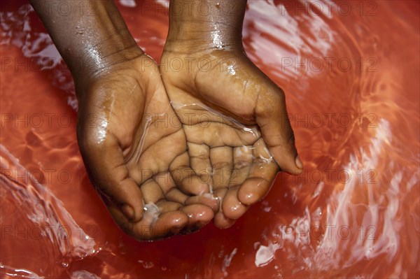 Children washing their hands in fresh