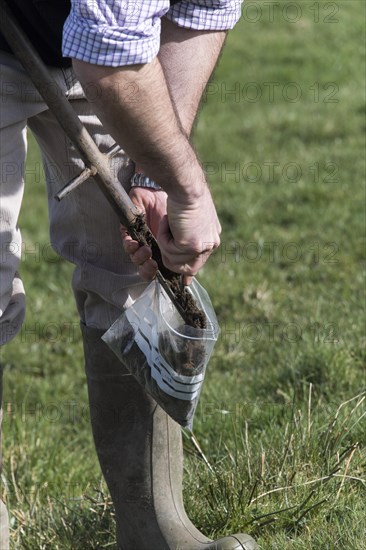 Agricultural expert taking soil samples for testing off a pasture in the Yorkshire Dales