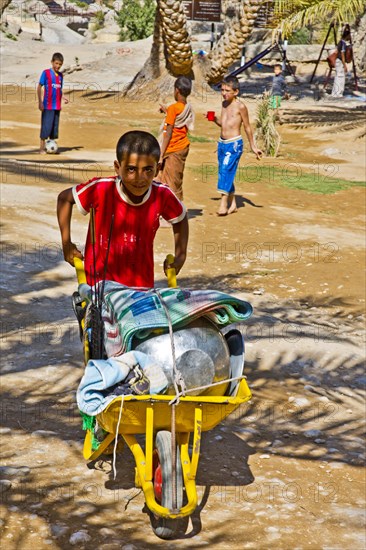 Transporting picnic utensils by wheelbarrow