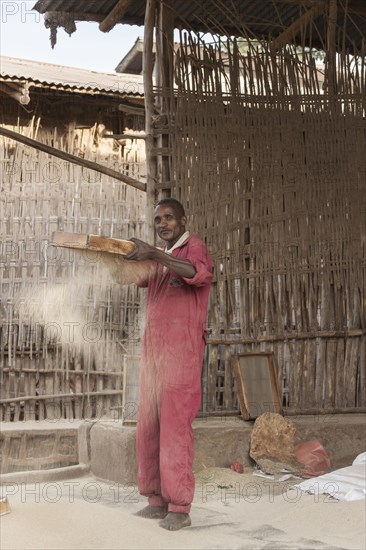 Man sifts flour