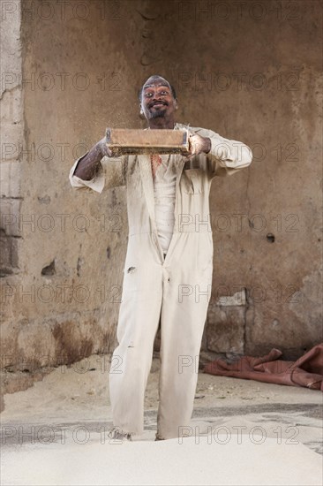 Man sifts flour