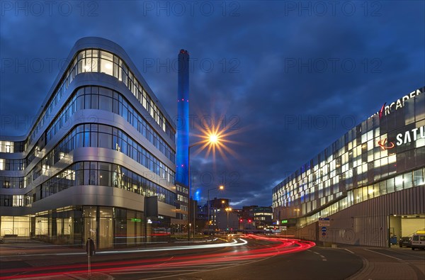 Chimney of the combined heat and power plant illuminated in the evening