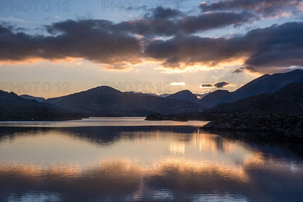 View of lake and mountains at sunset