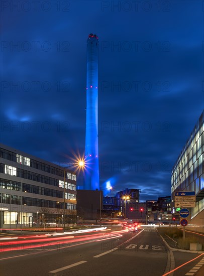 Chimney of the combined heat and power plant illuminated in the evening