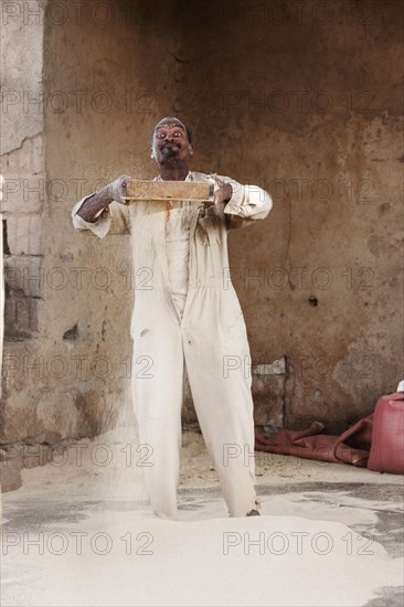 Man sifts flour