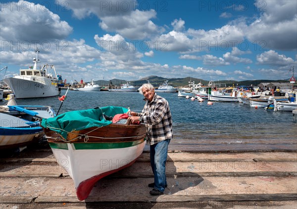 Sardinian fishermen in the harbour of Figari at Golfo Aranci