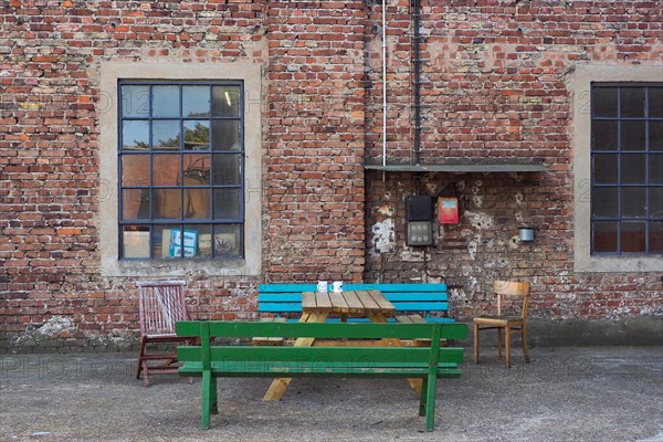 Factory hall on station premises with benches and table