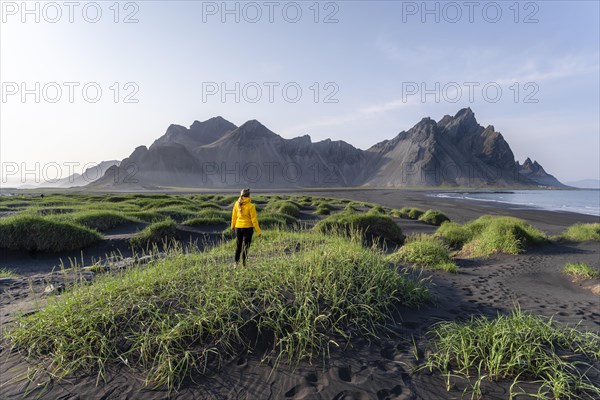 Young woman with rain jacket hiking