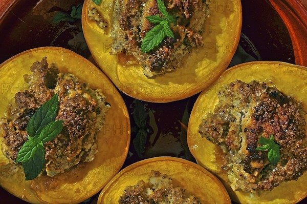 Dessert halved peaches with walnuts and mint leaf