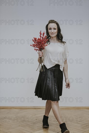 Woman with bouquet of rose hips